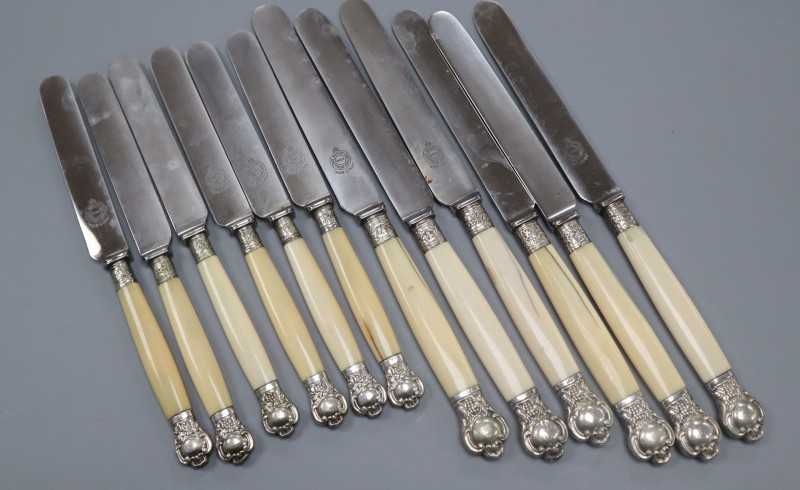 Six white metal mounted table knives and six dessert knives.